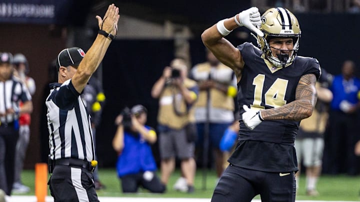 Sep 14, 2025; New Orleans, Louisiana, USA;  New Orleans Saints wide receiver Devaughn Vele (14) reacts to scoring a touchdown against San Francisco 49ers safety Jason Pinnock (25) during the second half at Caesars Superdome. Mandatory Credit: Stephen Lew-Imagn Images