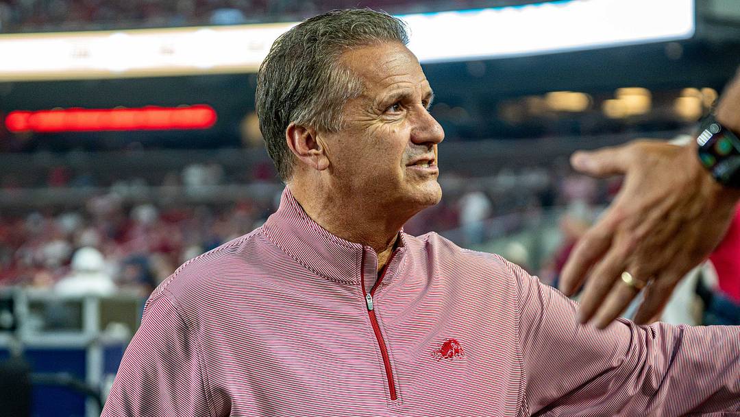Arkansas Razorbacks men's basketball coach John Calipari shakes hands with fans before the football game against Tulsa. Arkansas Razorbacks men's basketball coach John Calipari shakes hands with fans before the football game against Tulsa.