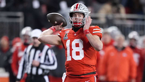 Ohio State quarterback Will Howard (18) pulls back for the throw