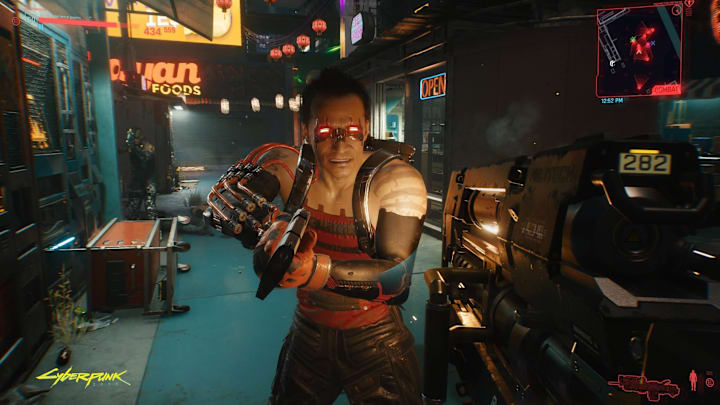 A modified human holds a sci-fi gun and the player aims one back at them in Cyberpunk 2077