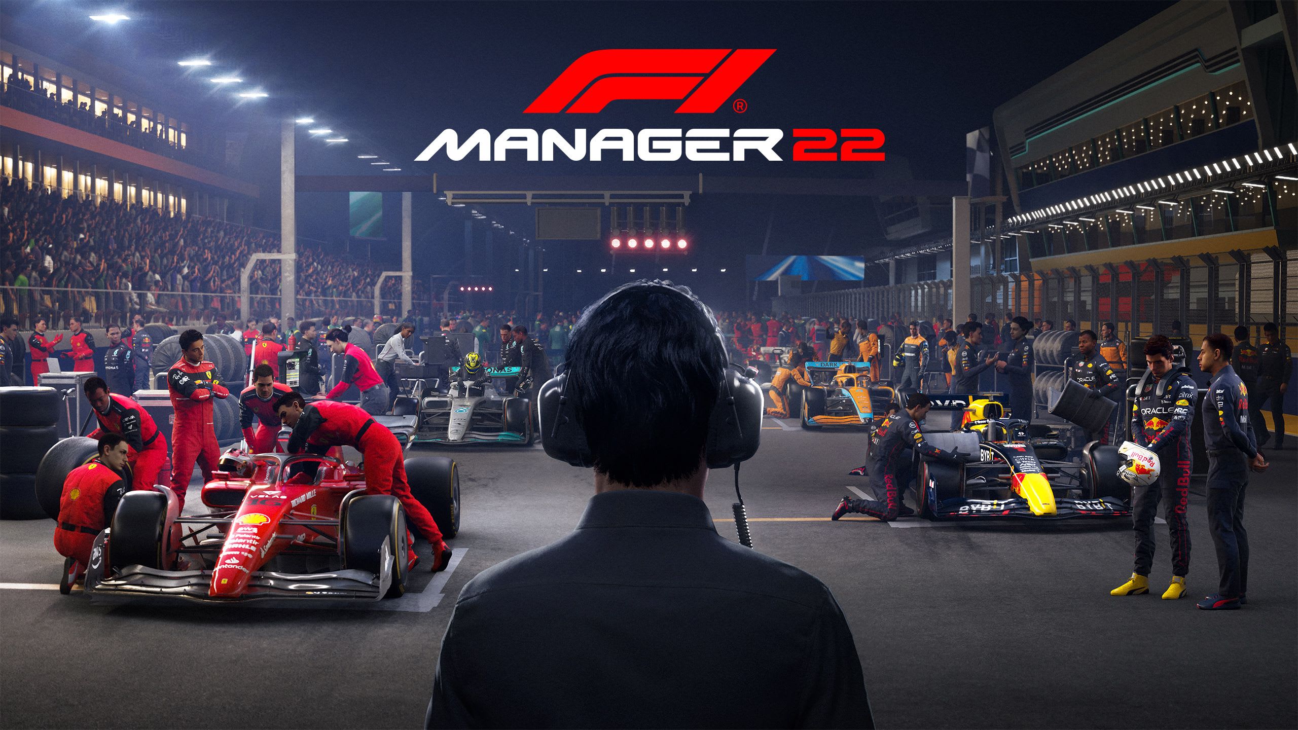 F1 Manager 2022 keyart showing cars being readied on the grid.