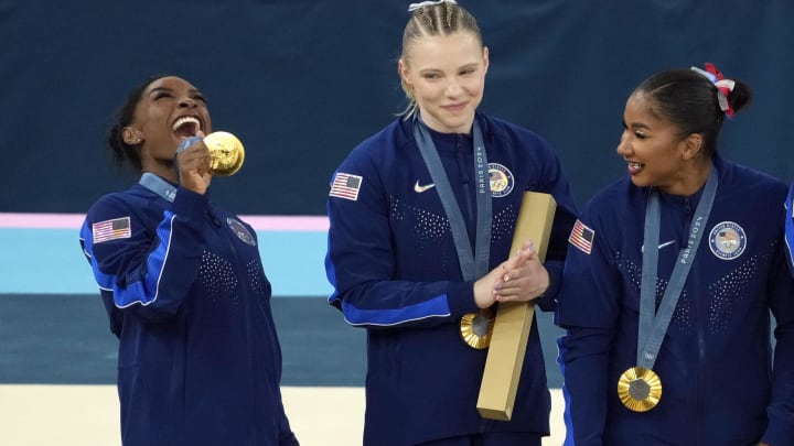 Jul 30, 2024; Paris, France; Simone Biles of the United States celebrates with her gold medal after the women’s team final at the Paris 2024 Olympic Summer Games at Bercy Arena. 