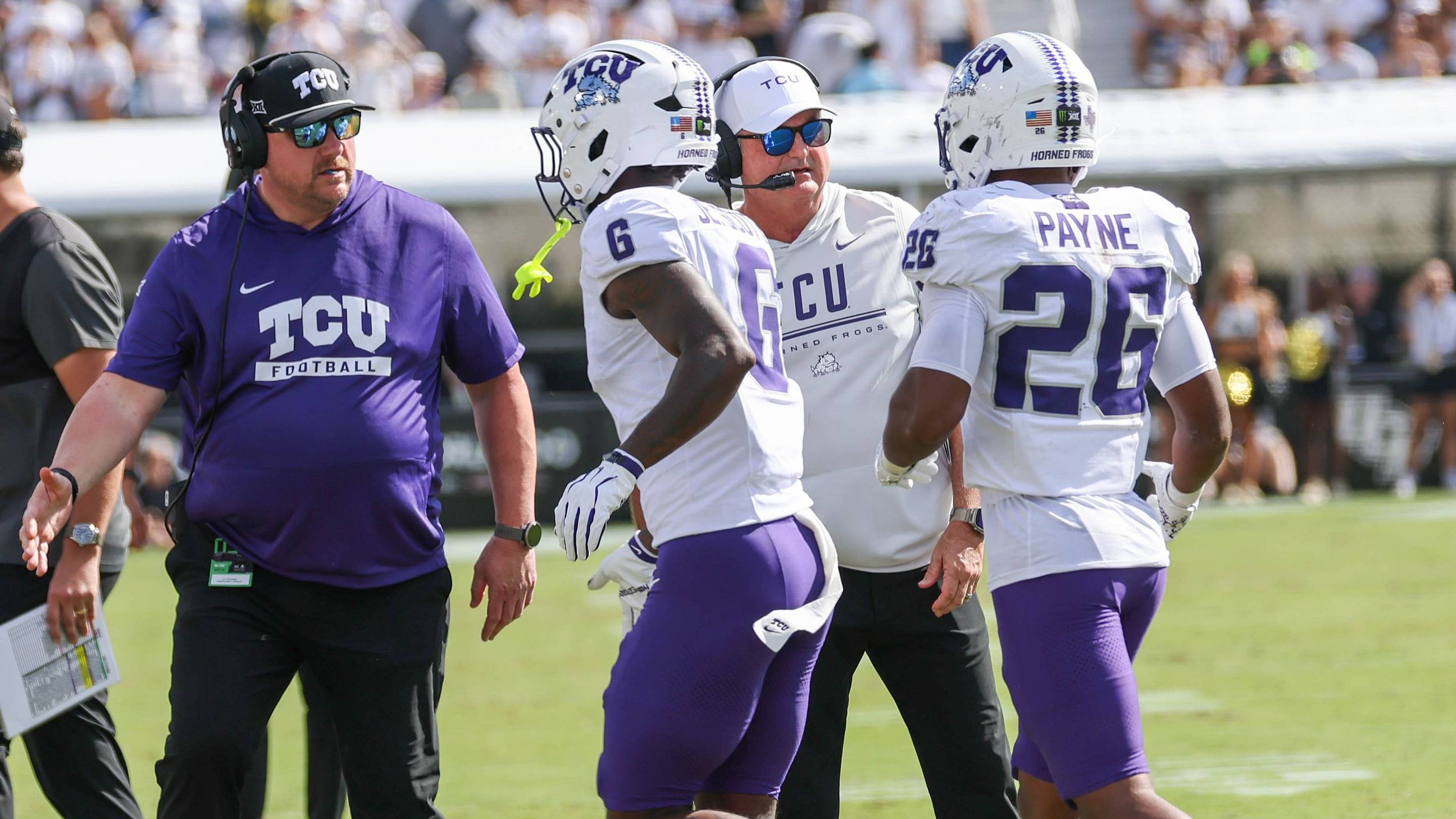 TCU players and coaches gather on the sideline during the Horned Frogs’ Big 12 road matchup against UCF in Orlando.