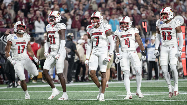 The Louisville defense celebrated after sacking FSU punter Alex Mastromanno (29) as the Louisville Cardinals faced off against the Florida State Seminoles at Bank of America Field in Charlotte, NC.