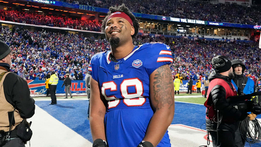 Bills tackle Tylan Grable smiles as he stops and watches a tribute video on the scoreboards as he leaves the field following the Bills win over the Jets.