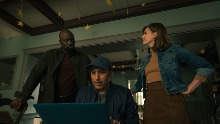 David (Mike Colter) and Kristen (Katja Herbers) stand behind  Ben (Aasif Mandvi) as he reviews something on a laptop