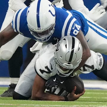 Indianapolis Colts defensive end Tyquan Lewis (94) brings down Las Vegas Raiders quarterback Geno Smith (7) on Sunday, Oct. 5, 2025, during a game at Lucas Oil Stadium in Indianapolis. The Colts defeated the Raiders 40-6.