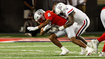 Aug 31, 2024; Tucson, Arizona, USA; New Mexico Lobos running back Eli Sanders (6) get tackled by Arizona Wildcats linebacker Jacob Manu (5) during first quarter at Arizona Stadium. 