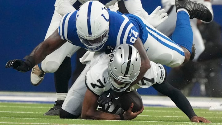 Indianapolis Colts defensive end Tyquan Lewis (94) brings down Las Vegas Raiders quarterback Geno Smith (7) on Sunday, Oct. 5, 2025, during a game at Lucas Oil Stadium in Indianapolis. The Colts defeated the Raiders 40-6.