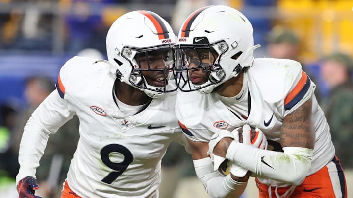Nov 9, 2024; Pittsburgh, Pennsylvania, USA; Virginia Cavaliers cornerback Jam Jackson (9) and safety Corey Thomas Jr. (right) celebrate an interception by Thomas against the Pittsburgh Panthers during the fourth quarter at Acrisure Stadium. Mandatory Credit: Charles LeClaire-Imagn Images