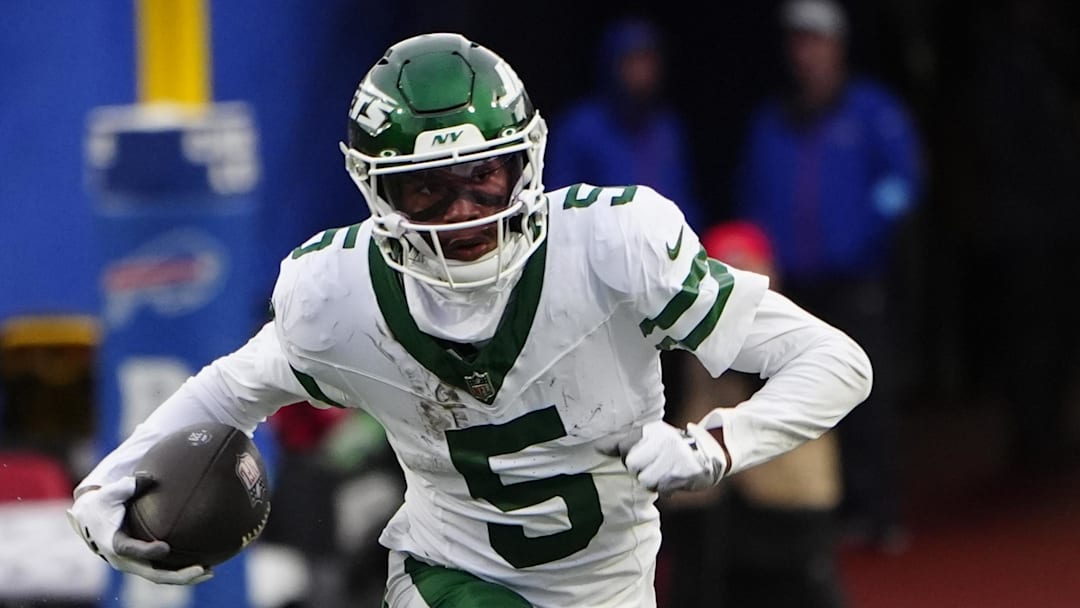 Dec 29, 2024; Orchard Park, New York, USA; New York Jets wide receiver Garrett Wilson (5) runs with the ball after making a catch against the Buffalo Bills during the second half at Highmark Stadium. 