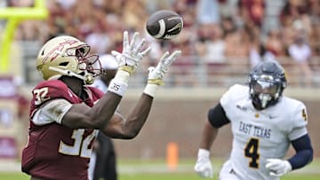 Sep 6, 2025; Tallahassee, Florida, USA; Florida State Seminoles running back Ousmane Kromah (32) catches a touchdown pass during the second half of the game against the East Texas A&M Lions at Doak S. Campbell Stadium. Mandatory Credit: Melina Myers-Imagn Images
