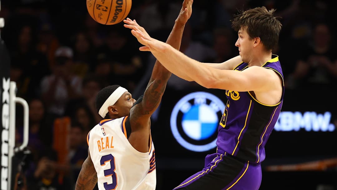 Oct 28, 2024; Phoenix, Arizona, USA; Los Angeles Lakers guard Austin Reaves (15) passes the ball against Phoenix Suns guard Bradley Beal (3) at Footprint Center. Mandatory Credit: Mark J. Rebilas-Imagn Images