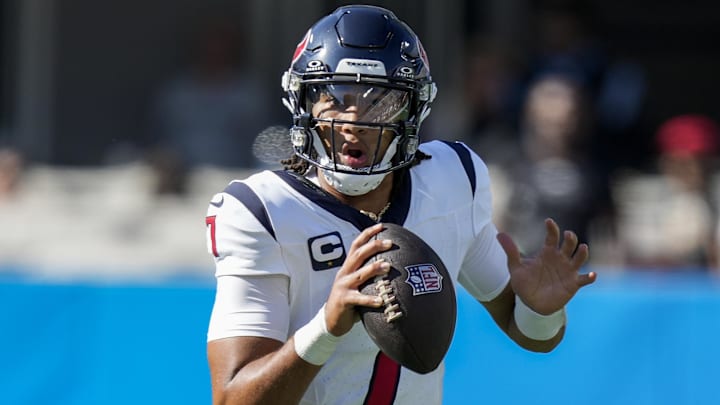 Oct 29, 2023; Charlotte, North Carolina, USA; Houston Texans quarterback C.J. Stroud (7) scrambles out of the pocket to pass against the Carolina Panthers during the second half at Bank of America Stadium. Mandatory Credit: Jim Dedmon-Imagn Images
