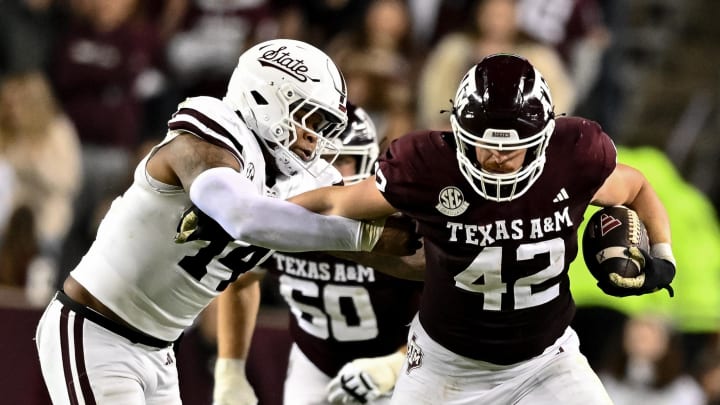 Nov 11, 2023; College Station, Texas, USA; Texas A&M Aggies tight end Max Wright (42) runs the ball as Mississippi State Bulldogs linebacker Nathaniel Watson (14) defends during the second half at Kyle Field. Mandatory Credit: Maria Lysaker-USA TODAY Sports