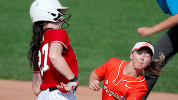 Nebraska's Brooke Andrews (27) makes it back to first as Oklahoma State's Rachel Becker (15) catches the ball in the sixth inning of a game between the Oklahoma State Cowgirls (OSU) and the Nebraska Cornhuskers