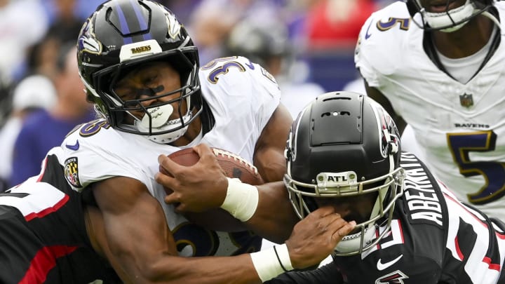 Aug 17, 2024; Baltimore, Maryland, USA;  Baltimore Ravens running back Owen Wright (36) grabs Atlanta Falcons safety Micah Abernathy (29) helmet while being tackled during the first half at M&T Bank Stadium. Mandatory Credit: Tommy Gilligan-USA TODAY Sports