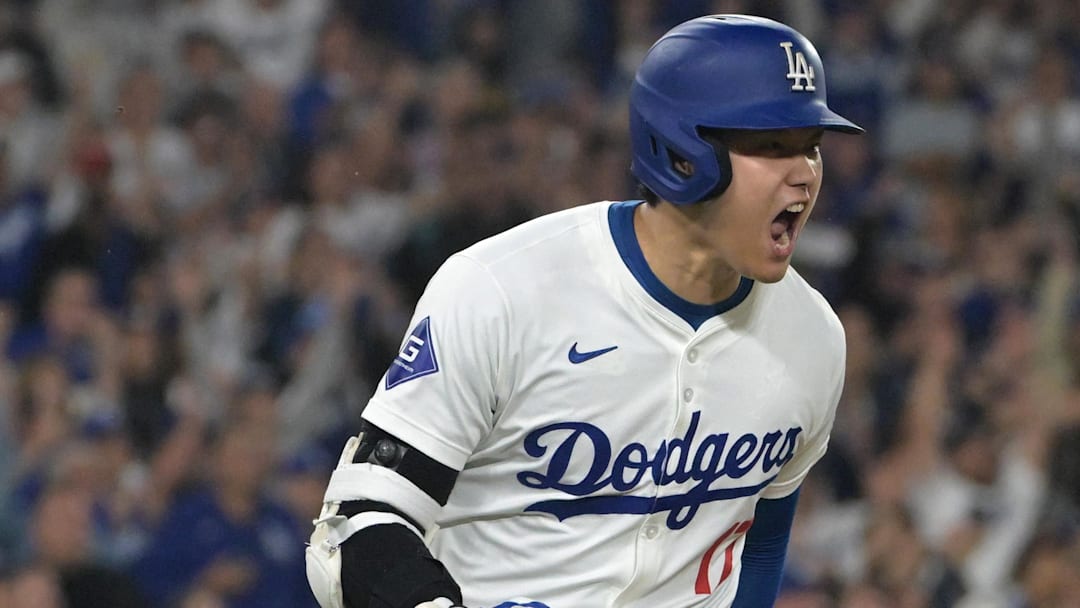 Sep 26, 2024; Los Angeles, California, USA;  Los Angeles Dodgers designated hitter Shohei Ohtani (17) celebrates as he runs to first after he singled in the go ahead run in the seventh inning against the San Diego Padres at Dodger Stadium. Mandatory Credit: Jayne Kamin-Oncea-Imagn Images