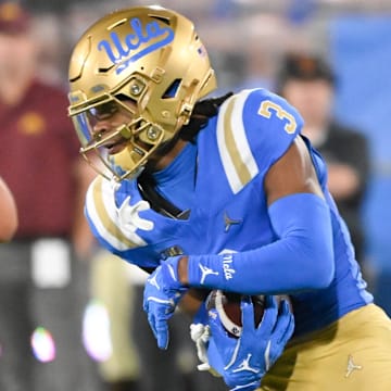 Oct 12, 2024; Pasadena, California, USA; UCLA Bruins wide receiver Kwazi Gilmer (3) runs past Minnesota Golden Gophers defensive lineman Deven Eastern (91) during the second quarter  at Rose Bowl. Mandatory Credit: Robert Hanashiro-Imagn Images