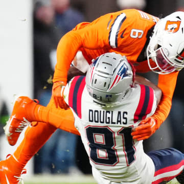 Dec 24, 2023; Denver, Colorado, USA; Denver Broncos safety P.J. Locke (6) tackles New England Patriots wide receiver Demario Douglas (81) in the second quarterf at Empower Field at Mile High. Mandatory Credit: Ron Chenoy-USA TODAY Sports