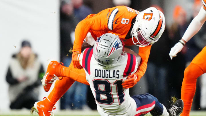 Dec 24, 2023; Denver, Colorado, USA; Denver Broncos safety P.J. Locke (6) tackles New England Patriots wide receiver Demario Douglas (81) in the second quarterf at Empower Field at Mile High. Mandatory Credit: Ron Chenoy-USA TODAY Sports