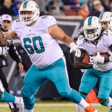 Guard Kraig Urbik (60) blocks for running back Jay Ajayi (23) during a late-season victory at MetLife Stadium in 2016.