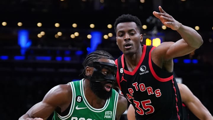 Apr 5, 2023; Boston, Massachusetts, USA; Boston Celtics guard Jaylen Brown (7) drives the ball against Toronto Raptors center Christian Koloko (35) in the second half at TD Garden. Mandatory Credit: David Butler II-Imagn Images