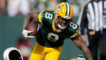 Arizona Cardinals defensive end Darius Robinson (56) loses his helmet tackling Green Bay Packers running back Josh Jacobs (8) on a first down run during their football game Sunday, October 13, 2024, at Lambeau Field in Green Bay, Wisconsin.