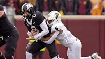 Oct 28, 2023; Minneapolis, Minnesota, USA; Minnesota Golden Gophers quarterback Athan Kaliakmanis (8) is sacked by Michigan State Spartans linebacker Jordan Hall (5) during the first quarter at Huntington Bank Stadium. Mandatory Credit: Nick Wosika-Imagn Images