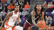 Jan 11, 2025; Clemson, South Carolina, USA; Florida State Seminoles guard Daquan Davis (5) grabs a loose ball against Clemson Tigers guard Dillon Hunter (2) during the first half at Littlejohn Coliseum. Mandatory Credit: Ken Ruinard/USA TODAY Network via Imagn Images