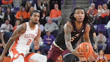 Jan 11, 2025; Clemson, South Carolina, USA; Florida State Seminoles guard Daquan Davis (5) grabs a loose ball against Clemson Tigers guard Dillon Hunter (2) during the first half at Littlejohn Coliseum. Mandatory Credit: Ken Ruinard/USA TODAY Network via Imagn Images