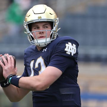 Notre Dame quarterback Riley Leonard (13) who is hurt, dresses and throws some pre-game passes with fellow quarterbacks Saturday, April 20, 2024, at the annual Notre Dame Blue-Gold spring football game at Notre Dame Stadium in South Bend.