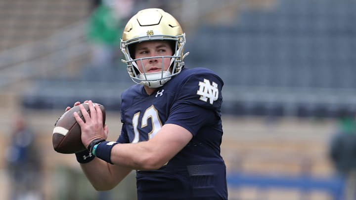 Notre Dame quarterback Riley Leonard (13) who is hurt, dresses and throws some pre-game passes with fellow quarterbacks Saturday, April 20, 2024, at the annual Notre Dame Blue-Gold spring football game at Notre Dame Stadium in South Bend.