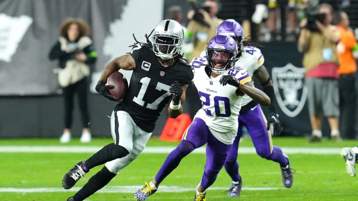 Dec 10, 2023; Paradise, Nevada, USA; Las Vegas Raiders wide receiver Davante Adams (17) gains yards ahead of Minnesota Vikings safety Jay Ward (20) during the final seconds of the fourth quarter at Allegiant Stadium. Mandatory Credit: Stephen R. Sylvanie-USA TODAY Sports