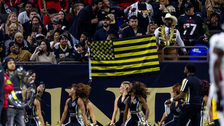 Jan 7, 2024; New Orleans, Louisiana, USA;  New Orleans Saints fans celebrate a touchdown against the Atlanta Falcons during the first half at Caesars Superdome. Mandatory Credit: Stephen Lew-USA TODAY Sports