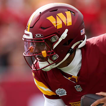 Sep 8, 2024; Tampa, Florida, USA; Washington Commanders quarterback Jayden Daniels (5) drops back to pass against the Tampa Bay Buccaneers in the first quarter at Raymond James Stadium. Mandatory Credit: Nathan Ray Seebeck-Imagn Images