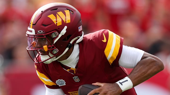 Sep 8, 2024; Tampa, Florida, USA; Washington Commanders quarterback Jayden Daniels (5) drops back to pass against the Tampa Bay Buccaneers in the first quarter at Raymond James Stadium. Mandatory Credit: Nathan Ray Seebeck-Imagn Images