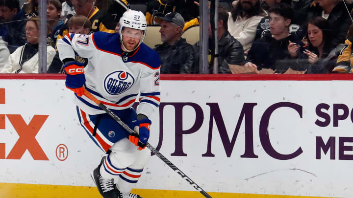 Mar 10, 2024; Pittsburgh, Pennsylvania, USA;  Edmonton Oilers defenseman Brett Kulak (27) moves the puck against the Pittsburgh Penguins during the first period at PPG Paints Arena. Mandatory Credit: Charles LeClaire-USA TODAY Sports