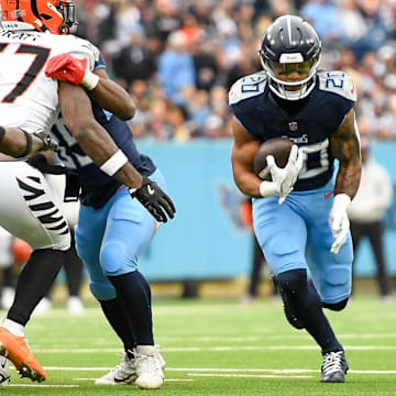 Dec 15, 2024; Nashville, Tennessee, USA;  Tennessee Titans running back Tony Pollard (20) runs the ball against the Cincinnati Bengals during the first half at Nissan Stadium. Mandatory Credit: Steve Roberts-Imagn Images