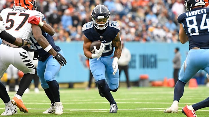 Dec 15, 2024; Nashville, Tennessee, USA;  Tennessee Titans running back Tony Pollard (20) runs the ball against the Cincinnati Bengals during the first half at Nissan Stadium. Mandatory Credit: Steve Roberts-Imagn Images