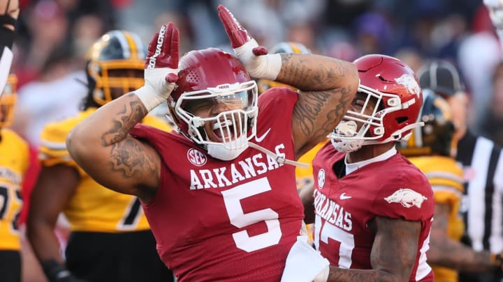 Arkansas Razorbacks defensive lineman Cameron Ball (5) celebrates after a tackle in the first quarter against the Missouri Tigers at Donald W. Reynolds Razorback Stadium. 
