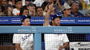 Aug 3, 2023; Los Angeles, California, USA;  Los Angeles Dodgers pitcher Clayton Kershaw (right) and Walker Buehler reacts in the dugout during the sixth inning against the Oakland Athletics at Dodger Stadium. 