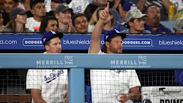 Aug 3, 2023; Los Angeles, California, USA;  Los Angeles Dodgers pitcher Clayton Kershaw (right) and Walker Buehler reacts in the dugout during the sixth inning against the Oakland Athletics at Dodger Stadium. 