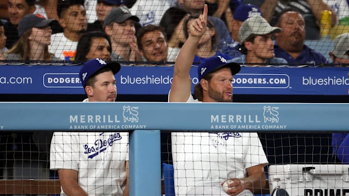 Aug 3, 2023; Los Angeles, California, USA;  Los Angeles Dodgers pitcher Clayton Kershaw (right) and Walker Buehler reacts in the dugout during the sixth inning against the Oakland Athletics at Dodger Stadium. 