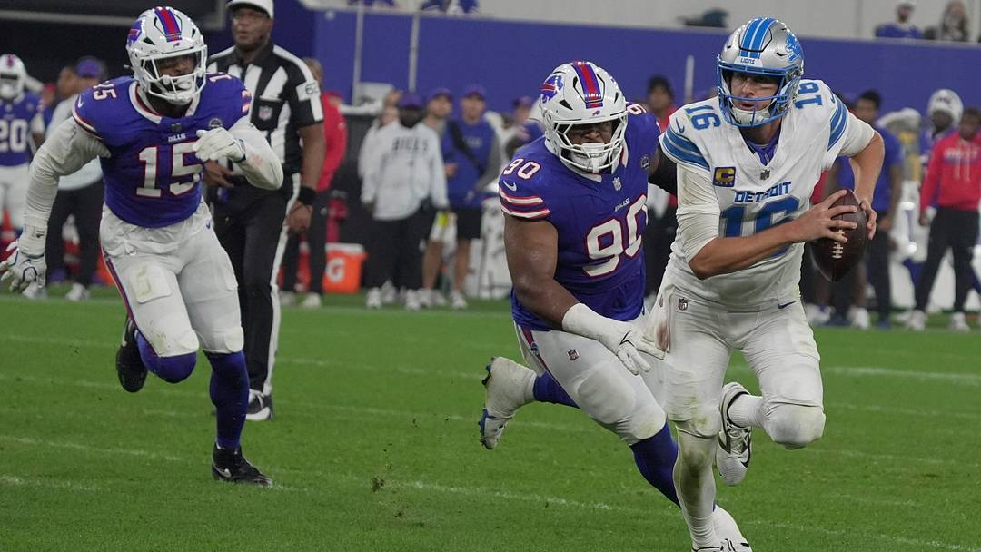Detroit Lions' quarterback Jared Goff keeps the ball and runs away from Buffalo Bills' defensive tackle DeWayne Carter during the second half at the Bills' home opener game against the Lions on Sept. 17, 2026.