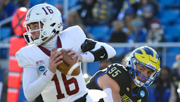 Lafayette quarterback Dean DeNobile (left) eludes Delaware defensive lineman Melkart Abou-Jaoude in the first quarter of the opening round of the NCAA FCS playoffs Saturday, Nov. 25, 2023 at Delaware Stadium.