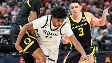 Michigan State guard Jase Richardson (11) dribbles against Oregon center Szymon Zapala (10), left, and guard Jaden Akins (3) during the second half of Big Ten Tournament quarterfinal at Gainbridge Fieldhouse in Indianapolis, Ind. on Friday, March 14, 2025.