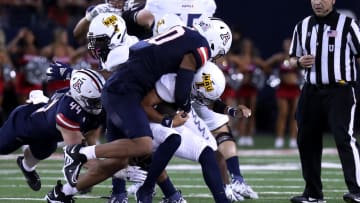Sep 2, 2023; Tucson, Arizona, USA; Arizona Wildcats defensive lineman Isaiah Ward (90) makes a tackle agaisnt Northern Arizona Lumberjacks quarterback Niko Haen (12) during the second half at Arizona Stadium. Mandatory Credit: Zac BonDurant-USA TODAY Sports