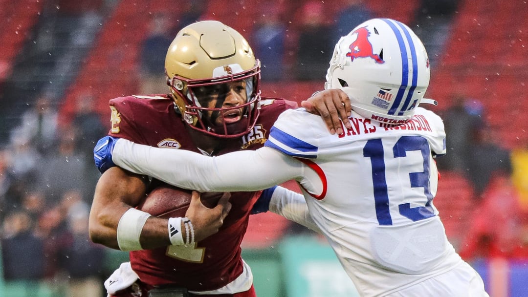 Boston College's Thomas Castellanos stiff-arms SMU's Jaelyn Davis-Robinson during the second annual Wasabi Fenway Bowl vs. SMU at Fenway Park on Thursday, Dec. 28, 2023.