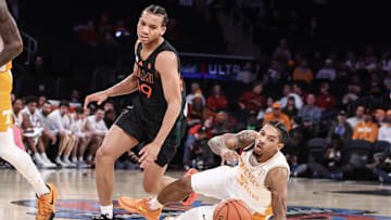 Dec 10, 2024; New York, New York, USA;  Miami Hurricanes guard Divine Ugochukwu (99) collides with Tennessee Volunteers guard Zakai Zeigler (5) in the first half at Madison Square Garden. Mandatory Credit: Wendell Cruz-Imagn Images